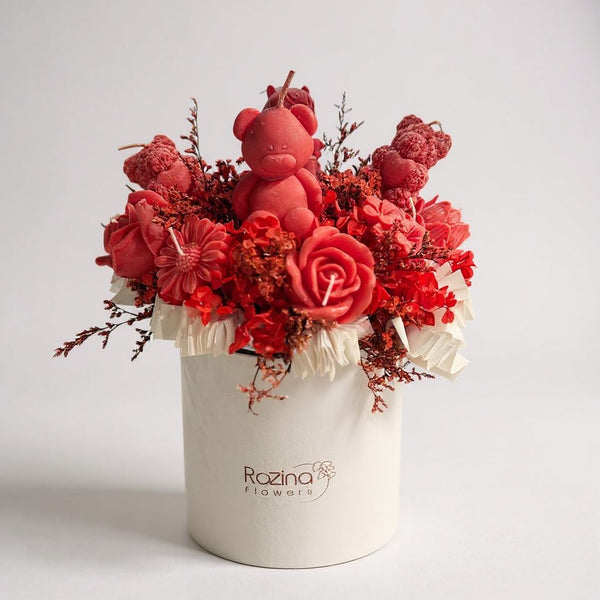 red candles in the box with dry flowers