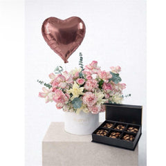 pink flower in the box with chocolate